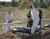 Forenses trabajan en un cementerio cerca de la ciudad recientemente recapturada de Lyman, zona de Donetsk.