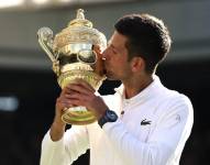 LONDON, ENGLAND - JULY 10: Novak Djokovic of Serbia kisses the trophy following his victory against Nick Kyrgios of Australia during their Men's Singles Final match on day fourteen of The Championships Wimbledon 2022 at All England Lawn Tennis and Croquet Club on July 10, 2022 in London, England. (Photo by Clive Brunskill/Getty Images)