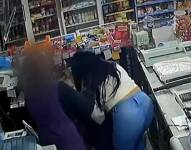 Momento en el que una mujer roba el dinero de la caja en una tienda.