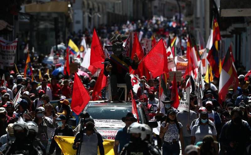 Manifestantes participan en una marcha con motivo del Día Internacional del Trabajo, este 1 de mayo de 2022, en Quito.