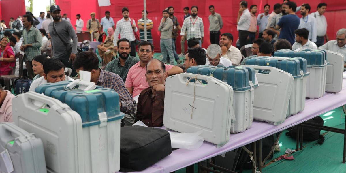 Funcionarios electorales indios con las máquinas de votación electrónica selladas esperan antes de su viaje a los colegios electorales para la primera fase de las elecciones parlamentarias o generales de 2024.