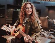 Thalía en el estudio junto a una guitarra.