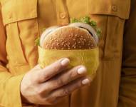 Mujer sosteniendo una hamburguesa.