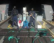 Foto de los dos detenidos junto al cargamento de droga, en una embarcación de la Armada del Ecuador.