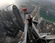 Remi Lucidi posando en la cima de un rascacielos en Dubai.
