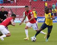 Enner Valencia se enfrenta a dos defensores chilenos.