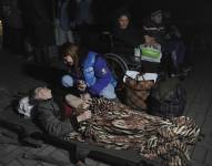 Una voluntaria atiende a una anciana a su llegada a Leópolis tras ser evacuada de la región de Luhansk.