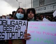 Dos jóvenes muestran carteles de protestan durante una movilización de cientos de mujeres que se toman las calles hoy con motivo del Día Internacional de la Mujer, en Quito (Ecuador). EFE/ José Jácome