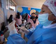 Una trabajadora de la salud prepara una dosis de la vacuna contra la covid-19 durante una jornada de vacunación a niños en un colegio de Quito (Ecuador).