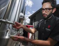 El gerente de producción de Sinners Micro Cervecería, Andrés Bermeo, sirve una muestra de la cerveza premiada recientemente en los World Beer Awards.