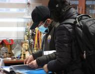 Los investigadores de la Policía Nacional revisan documentación en al GAD del Cotopaxi.