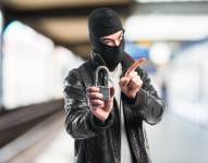 Robber holding vintage padlock