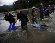 Migrantes cruzan el río Turquesa en Darién, en una fotografía de archivo.
