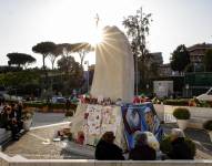 Las personas rezan frente a una estatua del Papa Juan Pablo II en la entrada del Hospital Gemelli, donde el Papa Francisco permanece hospitalizado, en Roma, Italia, 06 de marzo de 2025. El Papa Francisco fue admitido en el Hospital Agostino Gemelli de Roma el 14 de febrero de 2025 debido a una infección en las vías respiratorias.