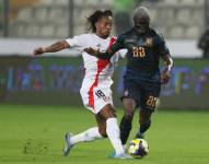 André Carrillo (i) de Perú disputa el balón con Moisés Caicedo de Ecuador este martes, en un partido por las Eliminatorias Sudamericanas para el Mundial 2026