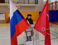 A woman casts her ballot in Russia's presidential election in Saint Petersburg on March 15, 2024. (Photo by Olga MALTSEVA / AFP)