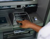 Imagen de una persona usadno un cajero automático.