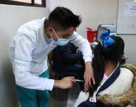 Una niña recibe una dosis de la vacuna contra la covid-19 en Quito (Ecuador). Fotografía de archivo. EFE/José Jácome