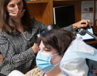 Prof Katherine Scangos checking Sarah's device and progress