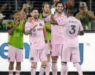 Lionel Messi celebra su gol con los ecuatorianos Leonardo Campana y Dixon Arroyo