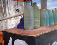 Un puesto improvisado ofrece diésel ecuatoriano en botellas de vidrio o pomas plásticas