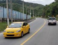 Imagen de un taxi color amarillo y una camioneta doble cabina circulando por la infraestructura vial del país.