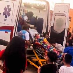Un niño siendo trasladado al hospital por ser herido por las balas en el evento la Chocolatada, en Perú.