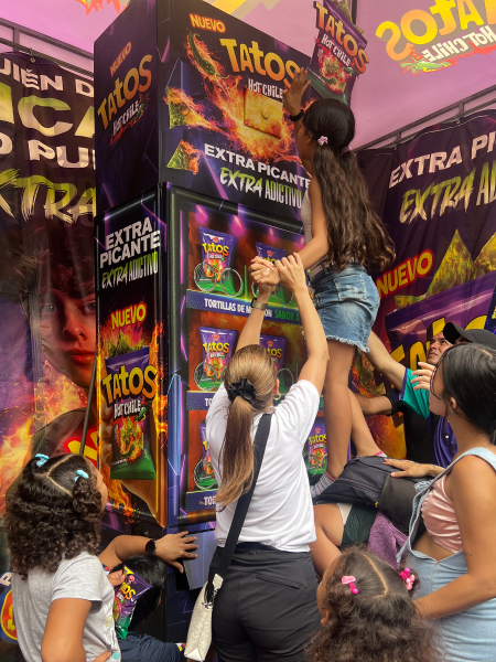 Ciudadanos participando del desafío de la máquina expendedora de Tatos Hot Chile en el Malecón 2000 de Guayaquil.