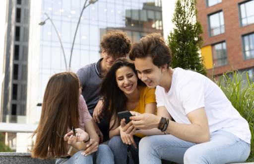 Amigos al aire libre en la ciudad mirando smartphone