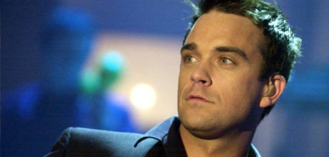 Robbie Williams admite que pagó para ser solista