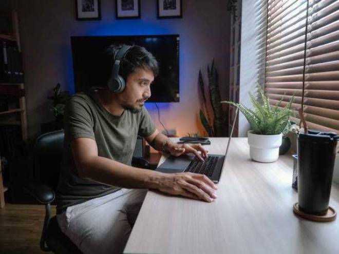 Hombre adulto jugando videojuegos en una laptop