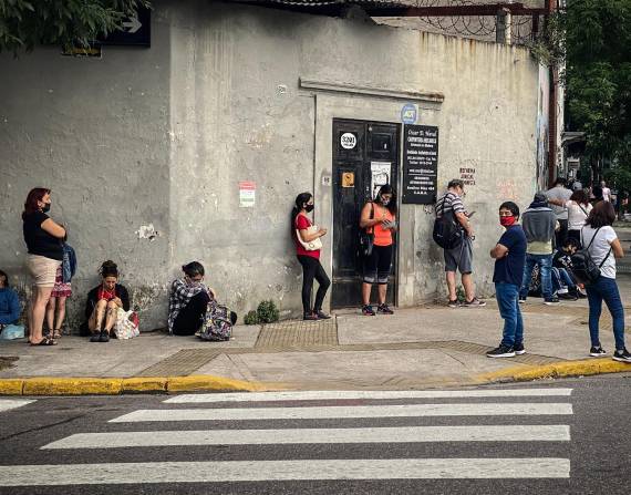 Personas haciendo fila para buscar empleo en Buenos Aires.