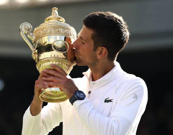 LONDON, ENGLAND - JULY 10: Novak Djokovic of Serbia kisses the trophy following his victory against Nick Kyrgios of Australia during their Men's Singles Final match on day fourteen of The Championships Wimbledon 2022 at All England Lawn Tennis and Croquet Club on July 10, 2022 in London, England. (Photo by Clive Brunskill/Getty Images)