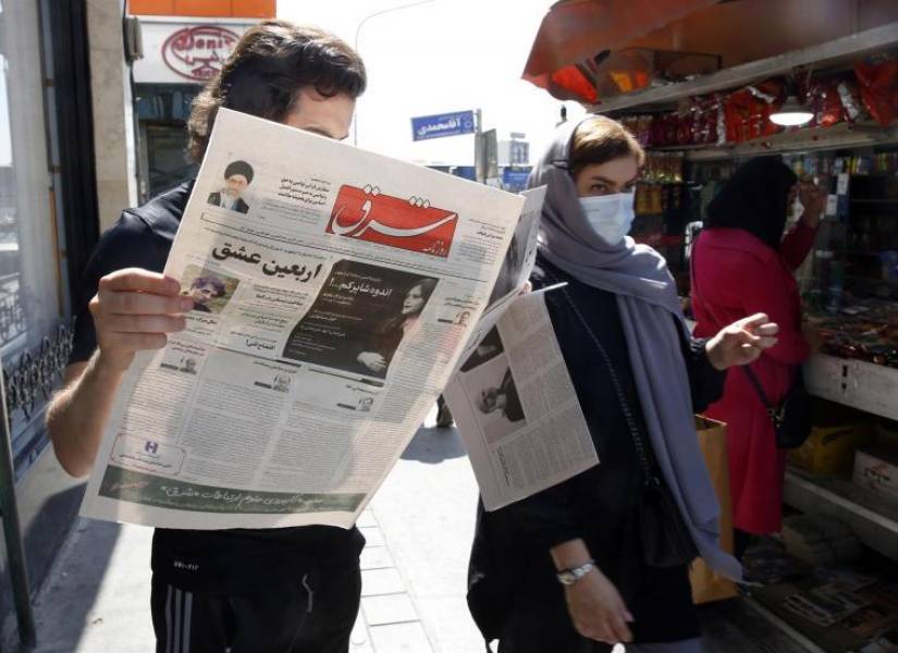 Un iraní leyendo uno de los periódicos reformistas que hablan de humillación en la muerte de Amini.
