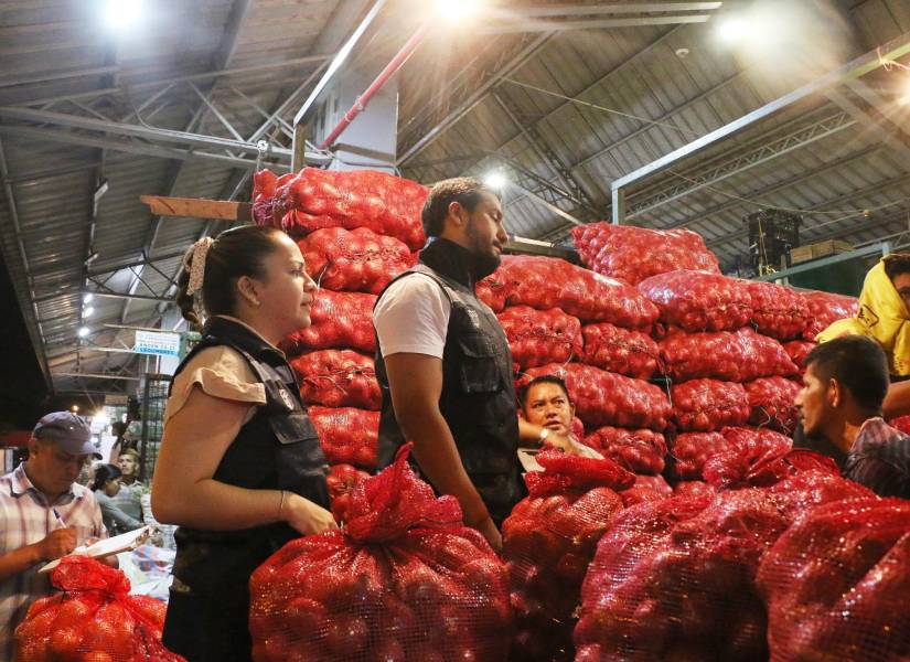 Imagen de inspectores revisando un puesto de venta de cebollas en el mercado de Montebello, en el norte de Guayaquil.