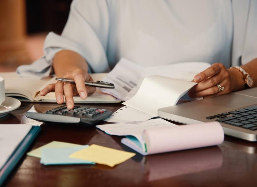 Hands of female entrepreneur working with bills and documents