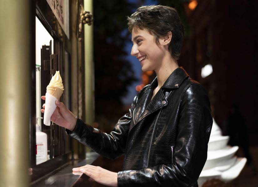 Mujer recibiendo un cono de helado.