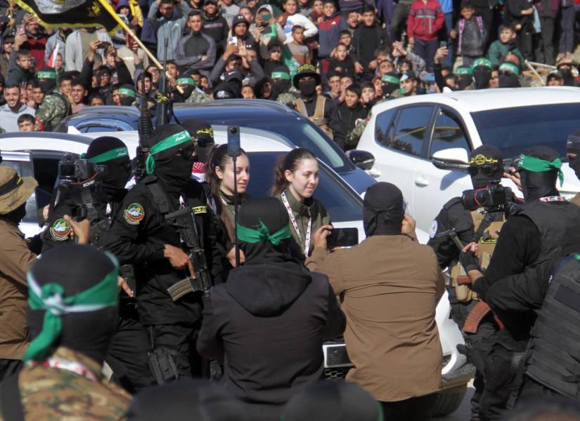 Las rehenes israelíes, Naama Levy y Karina Ariev, caminan antes de ser entregados al representante del Comité Internacional de la Cruz Roja.